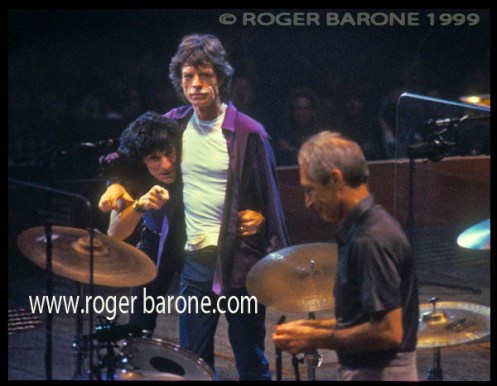 Mick Jagger holds Ronnie Wood in headlock
