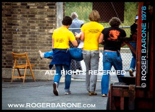 stones_security_fans_web Rowdy fan escorted from JFK Stadium Rolling Stones concert (6/17/1) photo: © roger barone