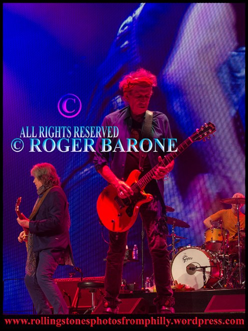 Keight Richards playing "Midnight Rambler" under colorful lights, Philly, june 21, 2013. photo by roger barone