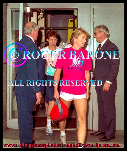 Rolling Stones Mick Jagger and trainer, Torje Eike, exit Four Seasons Hotel in Philly photo by roger barone 1989