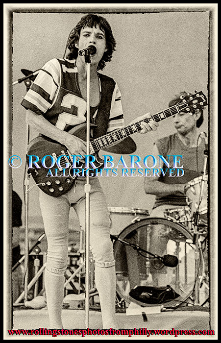 Mick Jagger wearing Eagles football jersey, plays gibson sg guitar at JFK Stadium, september 26, 1981